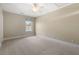 Bright bedroom with neutral walls, carpet, ceiling fan, and window with decorative curtain at 118 Wando Reach Rd, Wando, SC 29492