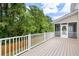 A wooden deck features white railings and screens with tree views in the background at 118 Wando Reach Rd, Wando, SC 29492