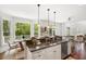 Spacious kitchen featuring granite countertops, stainless steel appliances, and access to a sunny outdoor patio at 118 Wando Reach Rd, Wando, SC 29492