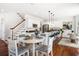 Bright, open kitchen features white cabinets, a central island, and dining area with hardwood floors and modern decor at 118 Wando Reach Rd, Wando, SC 29492