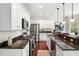 Modern kitchen showcasing stainless steel appliances, dark granite countertops, and ample white cabinetry for storage at 118 Wando Reach Rd, Wando, SC 29492