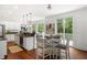 Bright kitchen features granite countertops, a central island, and a dining area with backyard views at 118 Wando Reach Rd, Wando, SC 29492