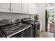 Well-equipped laundry room with modern appliances, ample storage, and convenient access to the outside at 118 Wando Reach Rd, Wando, SC 29492