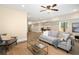 This modern living room has neutral walls, wood floors, ceiling fan, sofa, chairs, and a glass coffee table at 118 Wando Reach Rd, Wando, SC 29492