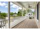 Inviting porch with a view of a pond, golf cart and hanging planters at 118 Wando Reach Rd, Wando, SC 29492