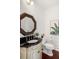 Stylish powder room features unique mirror, elegant sink, and modern fixtures for a sophisticated look at 118 Wando Reach Rd, Wando, SC 29492