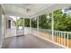 A screened porch featuring a ceiling fan, screens, and a door leading outside at 118 Wando Reach Rd, Wando, SC 29492