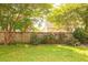 Manicured backyard with a wooden fence, large trees, and verdant grass at 120 Full Moon Ct, Ladson, SC 29456