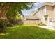 Backyard with green grass, a wooden fence, trees, bushes, and patio area at 120 Full Moon Ct, Ladson, SC 29456