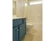 Cozy bathroom features a blue vanity, toilet, and shower with tiled walls at 120 Full Moon Ct, Ladson, SC 29456