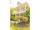 Charming two-story home with a spacious front porch and well-maintained landscaping, including a palm tree at 120 Full Moon Ct, Ladson, SC 29456