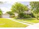 Attractive two-story home with a detached garage, long driveway, and well-kept lawn and mature trees at 120 Full Moon Ct, Ladson, SC 29456