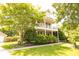 Charming two-story home featuring a welcoming front porch and lush landscaping, plus attached garage at 120 Full Moon Ct, Ladson, SC 29456