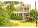 Beautiful two-story house with a welcoming front porch and manicured lawn surrounded by trees and greenery at 120 Full Moon Ct, Ladson, SC 29456