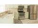 Modern kitchen featuring stainless steel appliances, light green cabinets, and beautiful countertops at 120 Full Moon Ct, Ladson, SC 29456