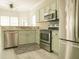 Well-equipped kitchen with stainless steel appliances, green cabinets, and ample countertop space at 120 Full Moon Ct, Ladson, SC 29456
