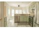 Modern kitchen with stainless steel appliances, light green cabinetry, granite countertops and ample natural light at 120 Full Moon Ct, Ladson, SC 29456