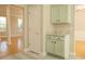 Cozy kitchen nook with green cabinets, granite countertops and pass through to bright living room at 120 Full Moon Ct, Ladson, SC 29456