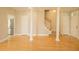 Spacious living room with hardwood floors, stairs, access to kitchen and doors that are bright and inviting at 120 Full Moon Ct, Ladson, SC 29456