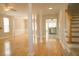 Spacious living room with hardwood floors, columns, and stairs leading to the second level with a kitchen in view at 120 Full Moon Ct, Ladson, SC 29456
