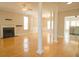 Bright living room boasting a fireplace, hardwood floors, stylish columns, and open access to the kitchen at 120 Full Moon Ct, Ladson, SC 29456