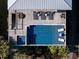 Drone shot of a home with a rectangular pool, lounge chairs, wooden deck, and a well-maintained landscaped yard at 124 Charleston Blvd, Isle of Palms, SC 29451