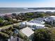 Beautiful aerial view of beachfront homes, offering stunning ocean views and surrounded by lush greenery, on a sunny day at 124 Charleston Blvd, Isle of Palms, SC 29451