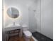 Contemporary bathroom features a sleek vanity, unique round mirror, and glass shower at 124 Charleston Blvd, Isle of Palms, SC 29451