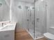 Modern bathroom features a glass-enclosed shower, double sink vanity, and stylish tile work at 124 Charleston Blvd, Isle of Palms, SC 29451