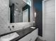 Stylish bathroom with a modern vanity, sleek mirror, and unique tile design at 124 Charleston Blvd, Isle of Palms, SC 29451