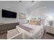 Comfortable bedroom with a large window, neutral tones, soft textures, and a mounted TV at 124 Charleston Blvd, Isle of Palms, SC 29451
