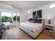 Bright bedroom features a balcony, large bed, and a view of the outdoors at 124 Charleston Blvd, Isle of Palms, SC 29451
