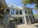 Stylish two-story home with modern windows, a unique round window, and stairs leading to the main entrance at 124 Charleston Blvd, Isle of Palms, SC 29451