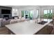 Open-concept kitchen with a marble island, stainless steel appliances, and a view of the living area at 124 Charleston Blvd, Isle of Palms, SC 29451