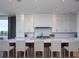 Spacious kitchen island with white cabinets, barstool seating, and pendant lighting above at 124 Charleston Blvd, Isle of Palms, SC 29451