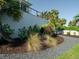 Lush landscaping featuring palm trees, shrubs, and a stone pathway along the side of the home at 124 Charleston Blvd, Isle of Palms, SC 29451