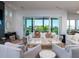 Cozy living room with a fireplace, comfortable seating, and scenic views at 124 Charleston Blvd, Isle of Palms, SC 29451