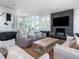 Spacious living room featuring modern decor, a fireplace, and bright natural light at 124 Charleston Blvd, Isle of Palms, SC 29451