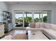 Inviting living room with a plush sofa, hardwood floors, and large sliding glass doors to the patio at 124 Charleston Blvd, Isle of Palms, SC 29451