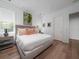 Serene main bedroom with plush bedding, a neutral color palette, and natural light from two windows at 124 Charleston Blvd, Isle of Palms, SC 29451