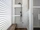 Outdoor shower with white shutters, wooden bench and black shower head at 124 Charleston Blvd, Isle of Palms, SC 29451