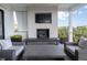 Relaxing outdoor patio featuring a fireplace, comfortable seating, and lush greenery at 124 Charleston Blvd, Isle of Palms, SC 29451