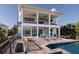 An attractive two-story home featuring a lovely deck and swimming pool, perfect for outdoor relaxation and entertainment at 124 Charleston Blvd, Isle of Palms, SC 29451