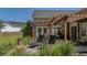 Backyard features stone patio with pergola, lounge chairs, and manicured lawn at 124 Corral Cir, Summerville, SC 29485