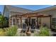 Relaxing backyard with a stone patio, a wooden pergola, and comfortable lounge chairs at 124 Corral Cir, Summerville, SC 29485