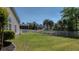 Spacious backyard featuring a lush lawn and white picket fence under a clear blue sky at 124 Corral Cir, Summerville, SC 29485