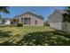 Well-maintained backyard featuring lush green grass, a pergola, and mature landscaping at 124 Corral Cir, Summerville, SC 29485