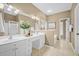 Well-lit bathroom featuring a double vanity sink, ample counter space, and a separate door for the toilet at 124 Corral Cir, Summerville, SC 29485