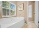 Relaxing bathroom with a large soaking tub under a window and a separate door to the toilet at 124 Corral Cir, Summerville, SC 29485