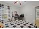 This spacious bedroom is staged as a teen bedroom with guitar and a large plaid comforter at 124 Corral Cir, Summerville, SC 29485